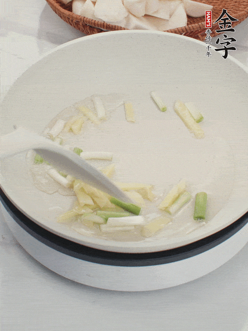 鍋中油五成熱，下蔥白、姜片爆香。