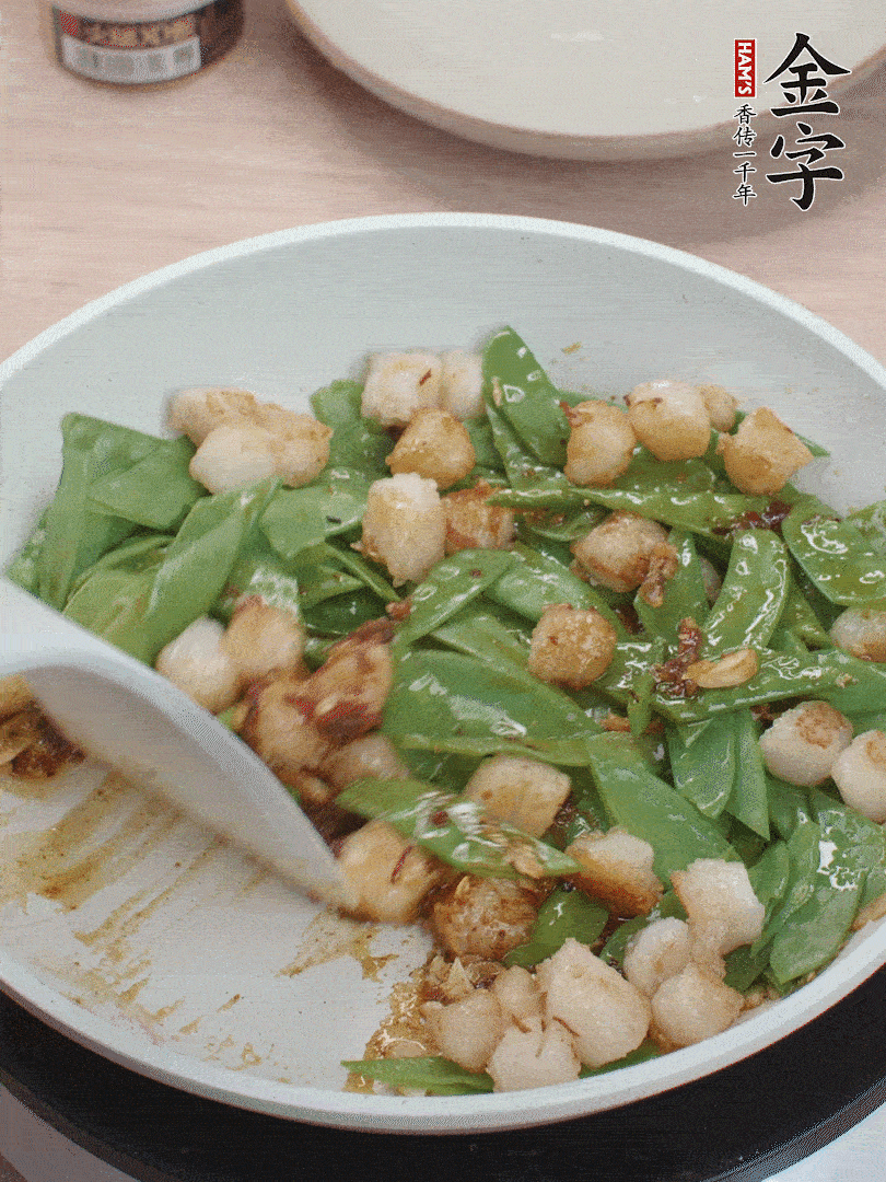 下甜豆莢、鮮貝輕輕翻炒均勻。